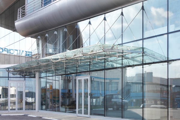 Transparent glass canopy providing weather protection and natural daylight