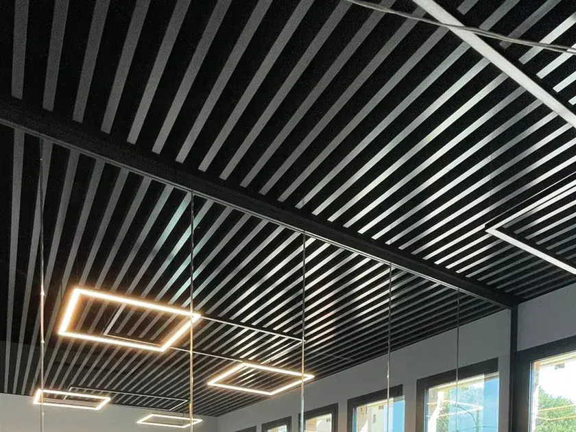 U-Baffle metal ceiling system with linear panels for modern commercial interiors