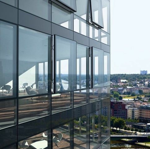 Unitized curtain wall glazing system with aluminium frames and large glass facade installed on a modern high-rise commercial building